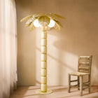 Palm Beach floor lamp illuminating a modern indoor, showcasing its palm-inspired design and ambient lighting.